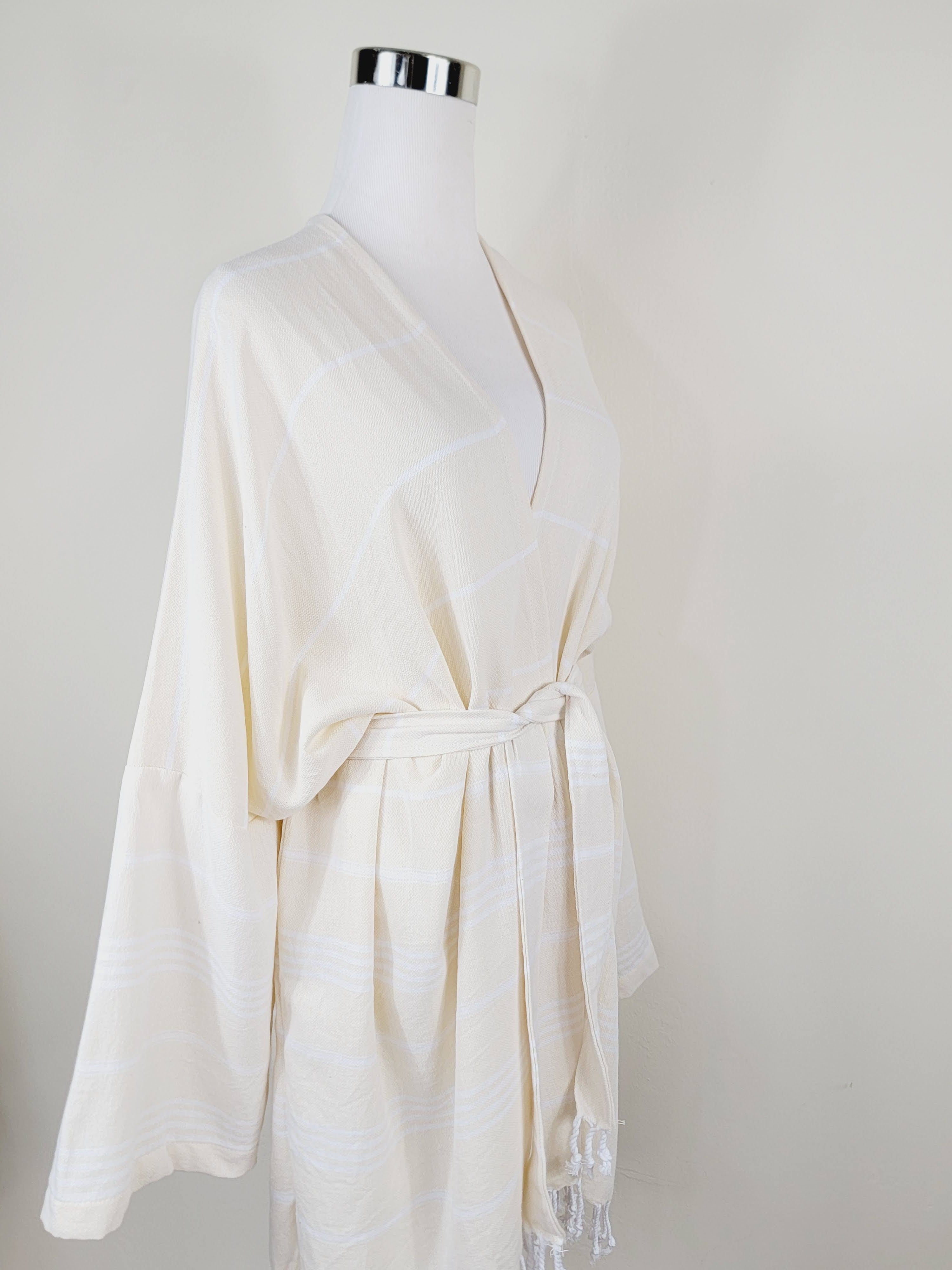 White robe on a mannequin against a plain background