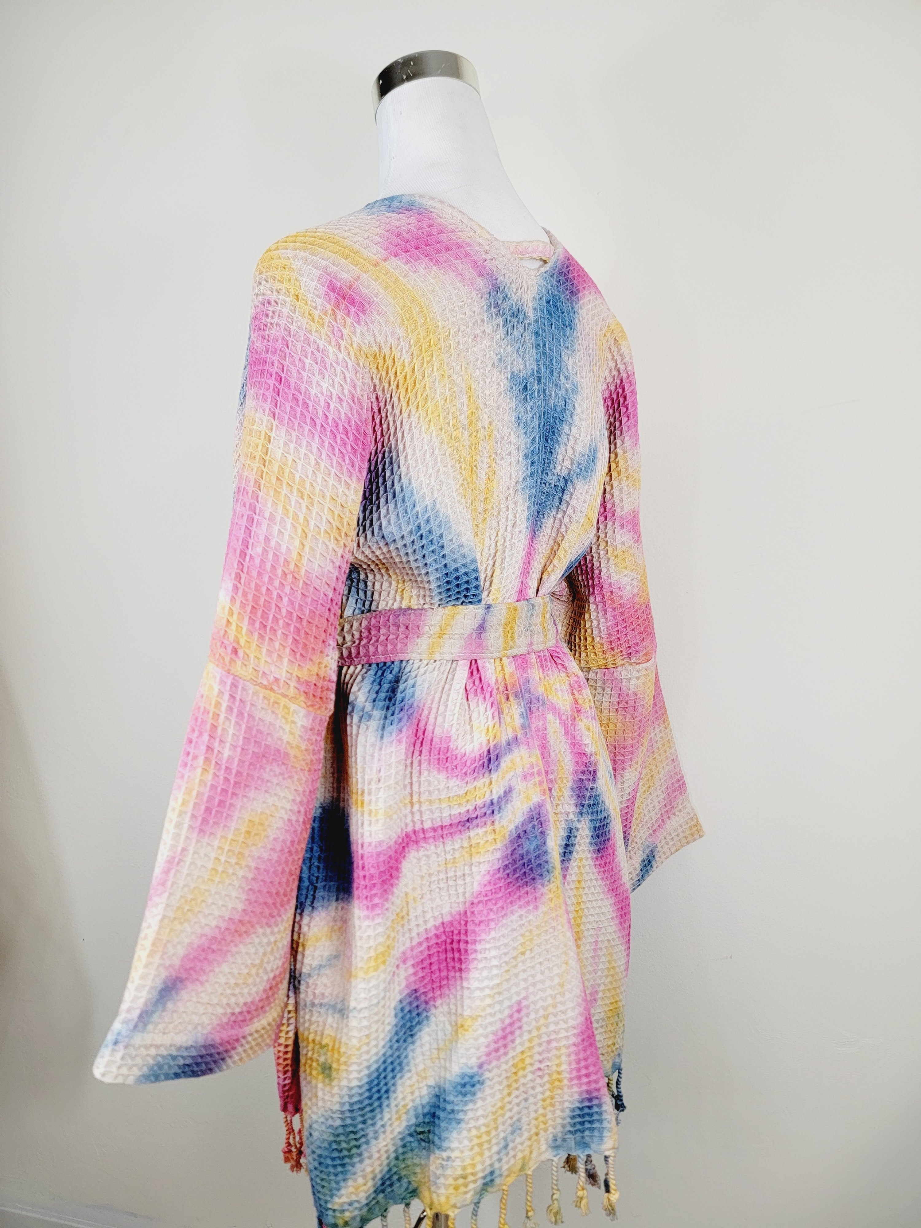 Colorful tie-dye kimono on a mannequin against a white background