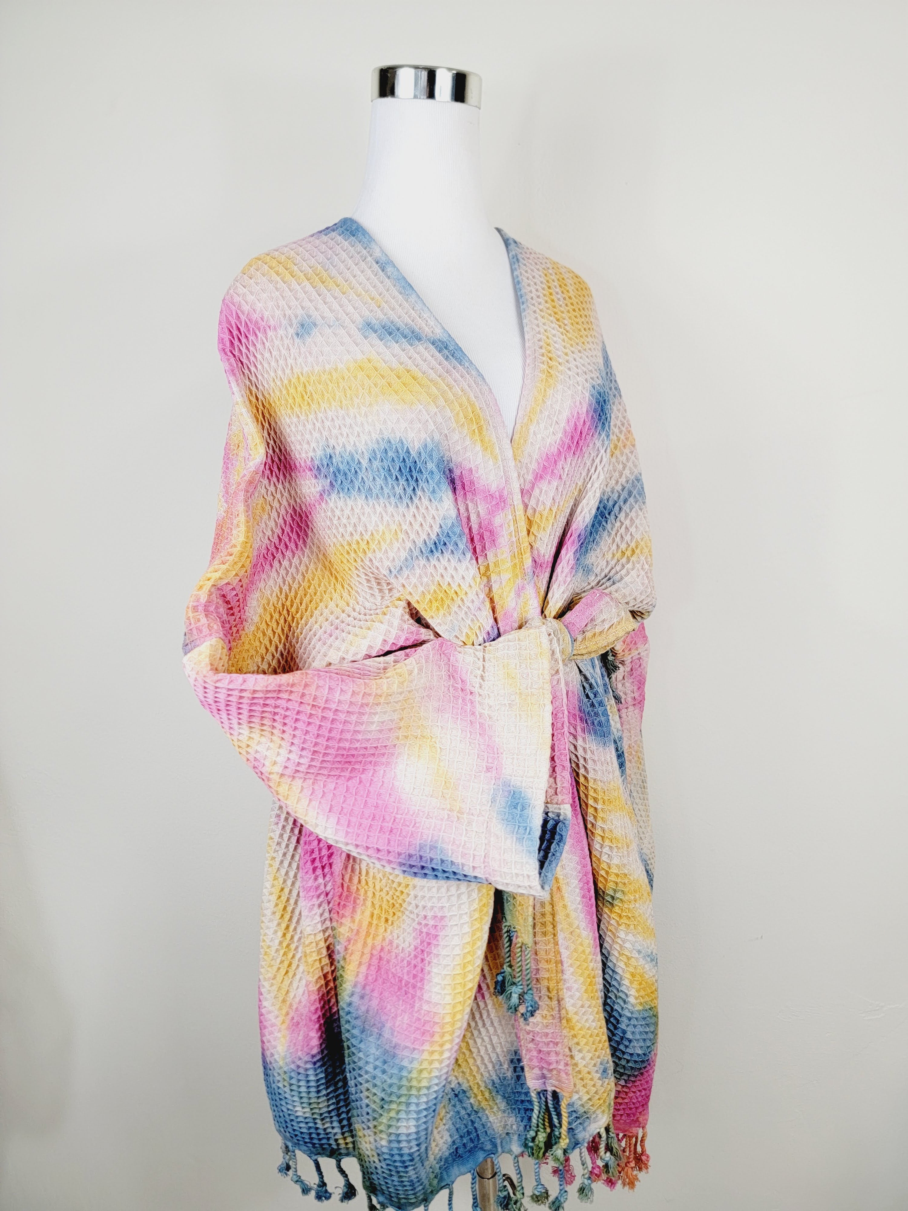 Colorful scarf on a mannequin against a white background