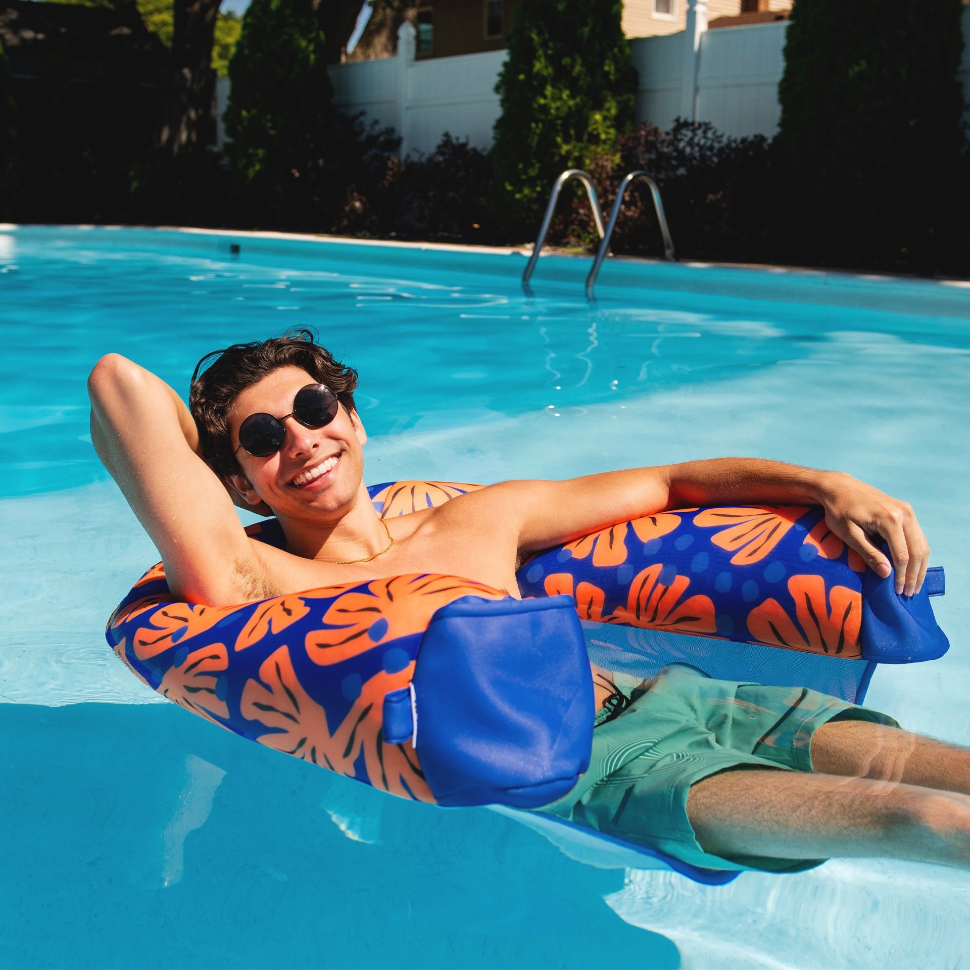 Person lounging on a colorful inflatable ring in a pool