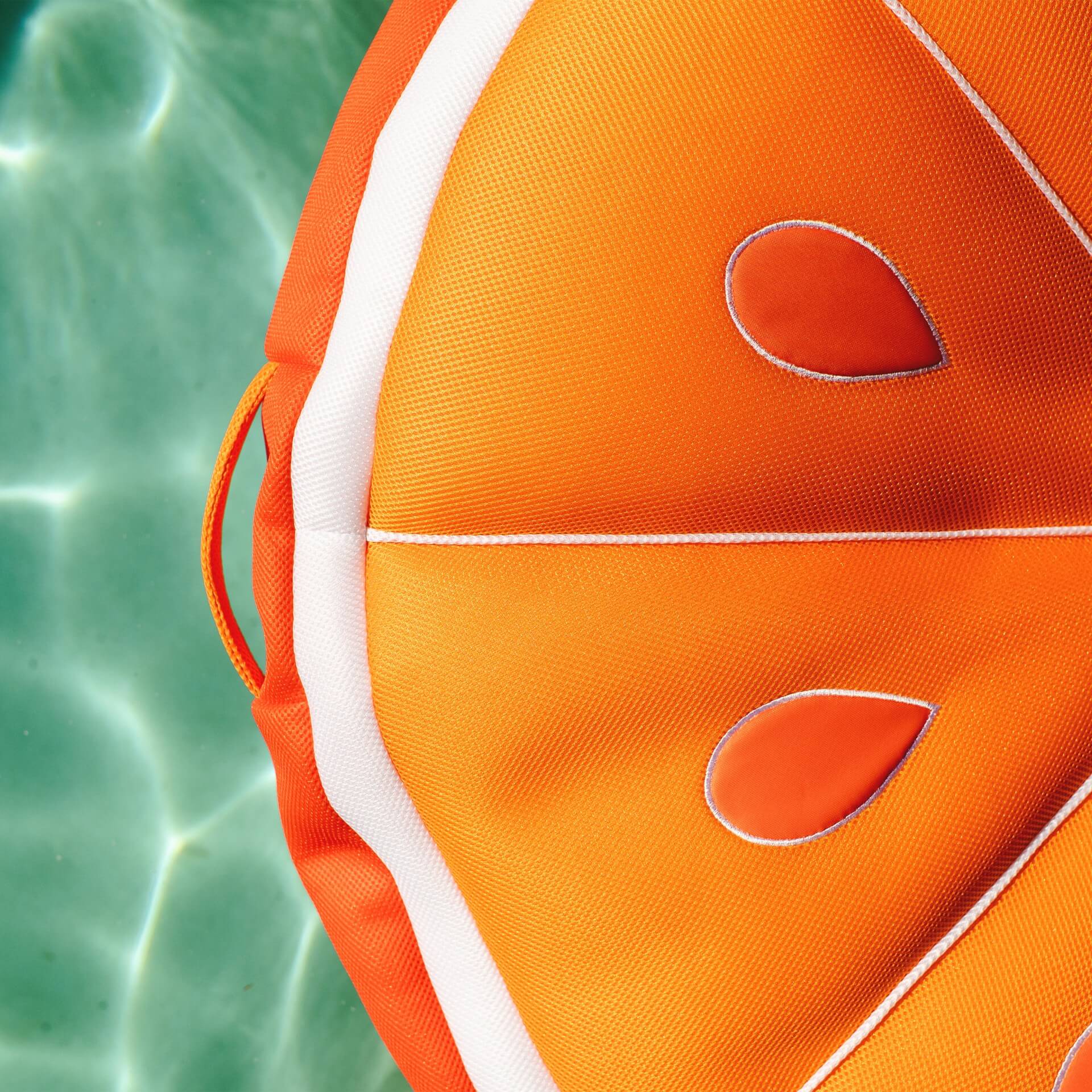 Close-up of an orange and white fabric item with a watercolor background