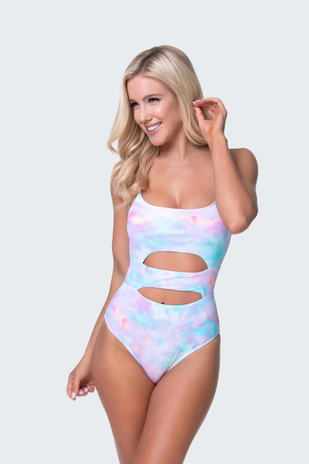 Woman wearing a colorful one-piece swimsuit on a white background