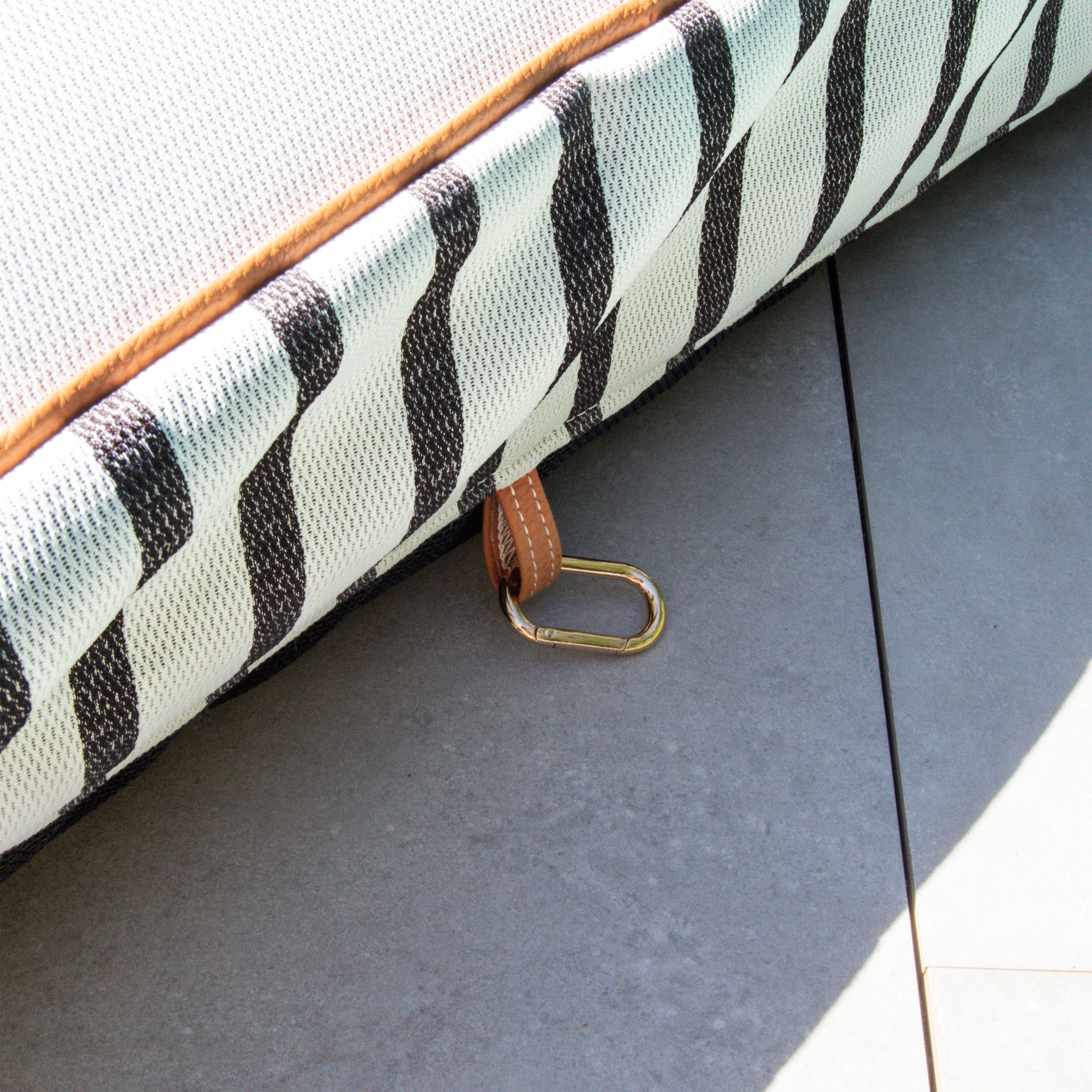 Zebra print bag with a strap on a gray surface