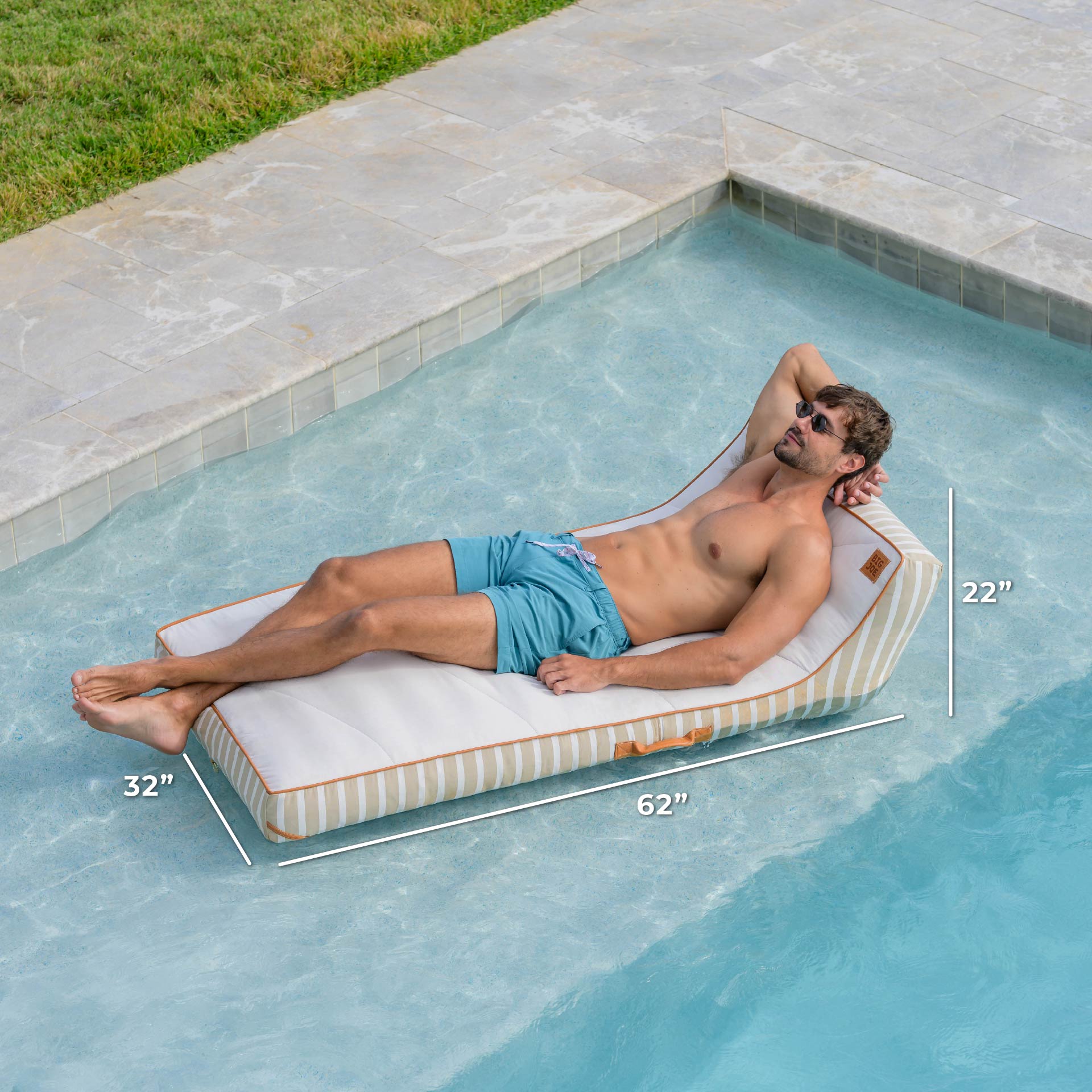 Man lying on a rectangular pool float with dimensions labeled, by a pool.