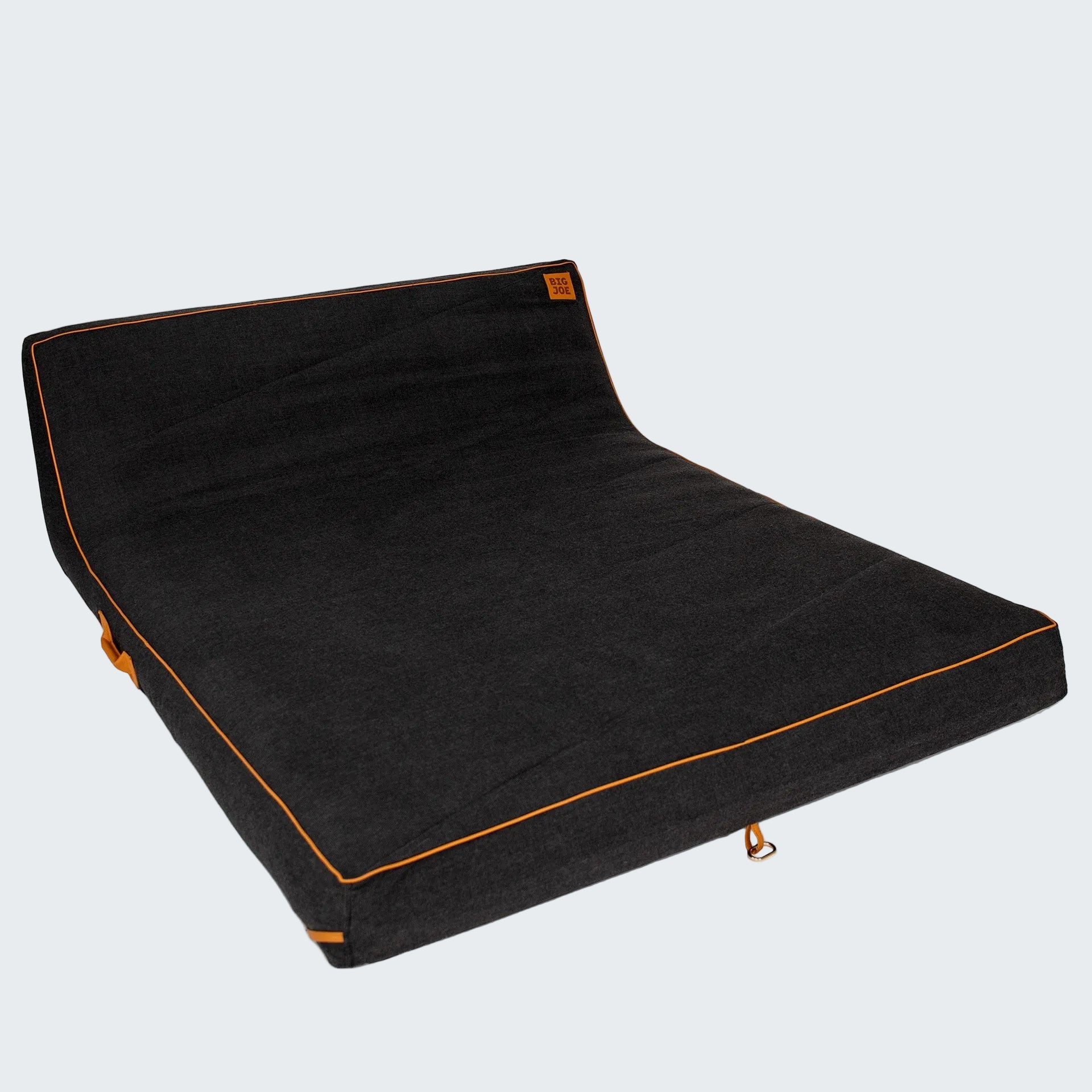 Black pet bed with orange stitching on a white background