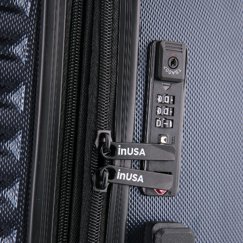 Close-up of a suitcase with a combination lock and 'inUSA' branding.