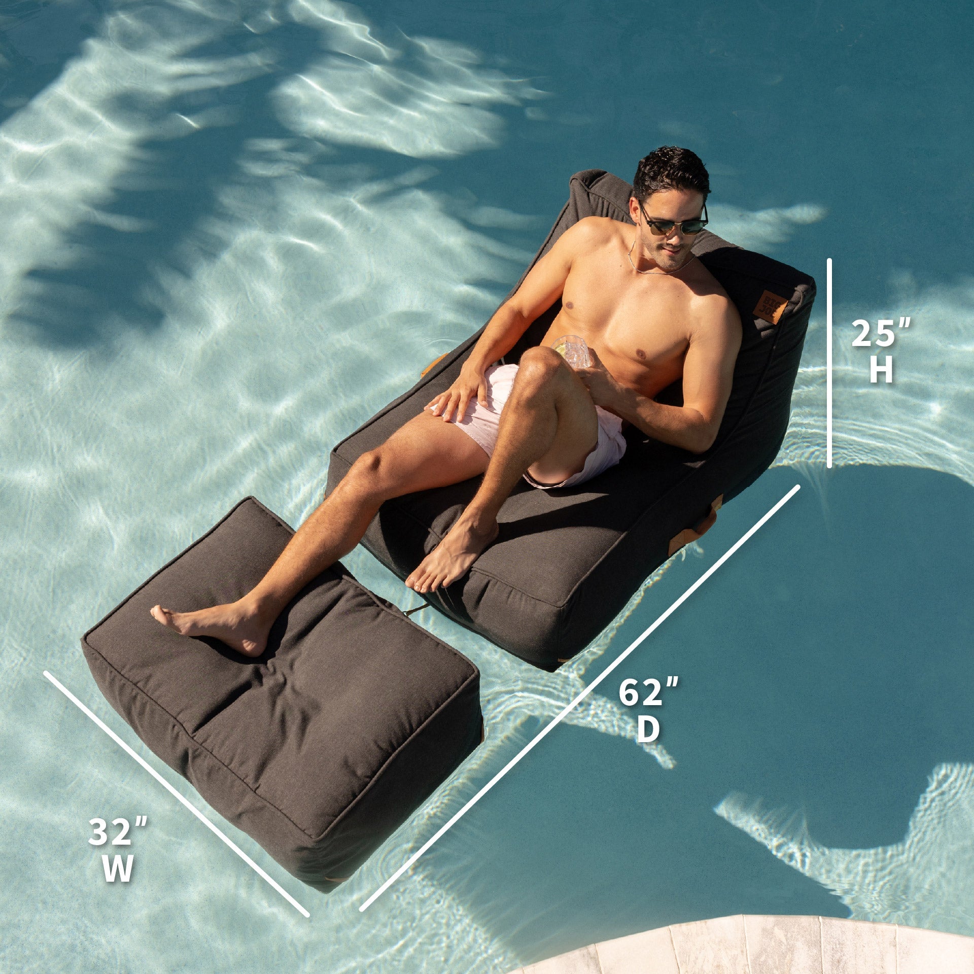 Man lounging on a black inflatable pool lounger with dimensions displayed, set against a pool background.