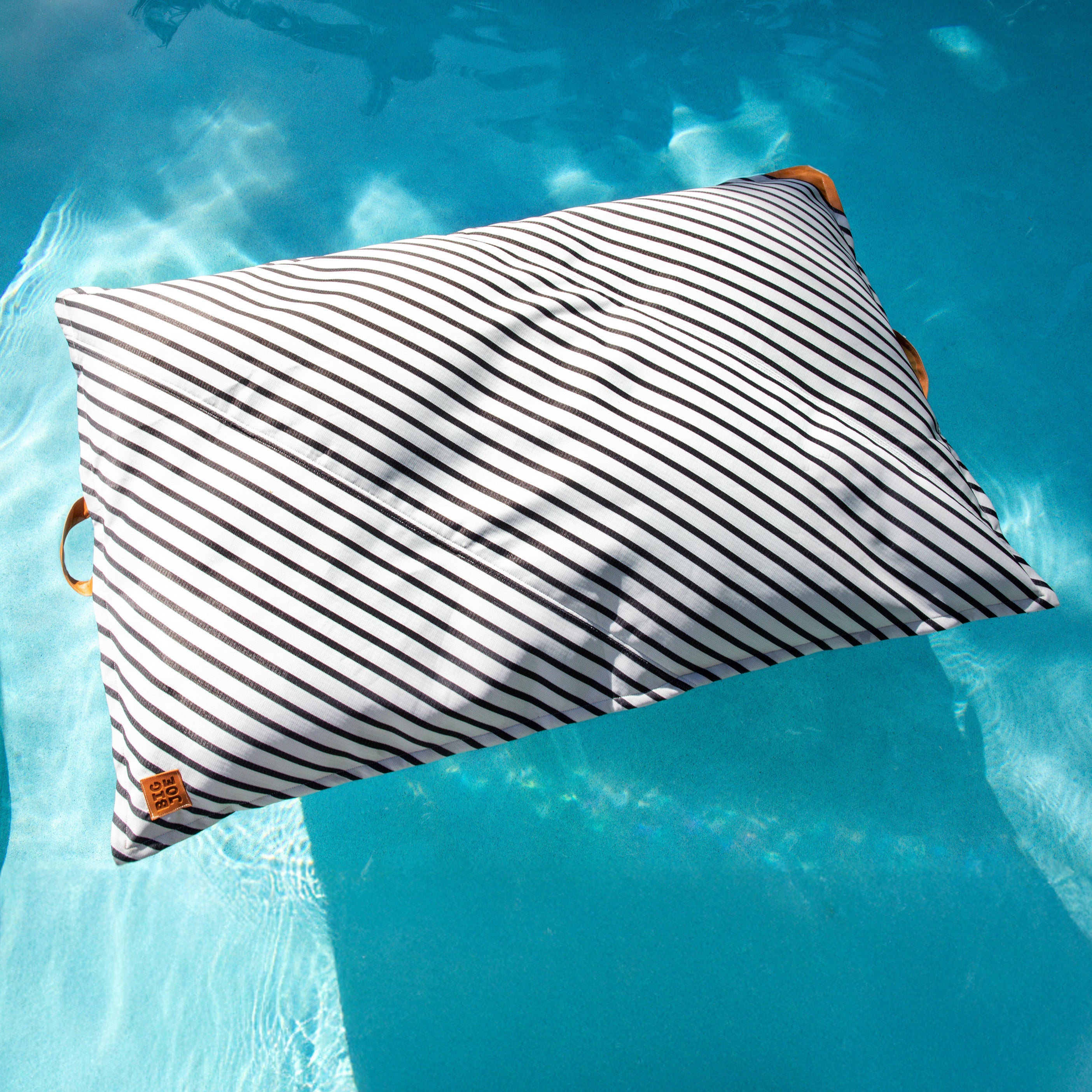 Striped pillow with wooden handles floating on water