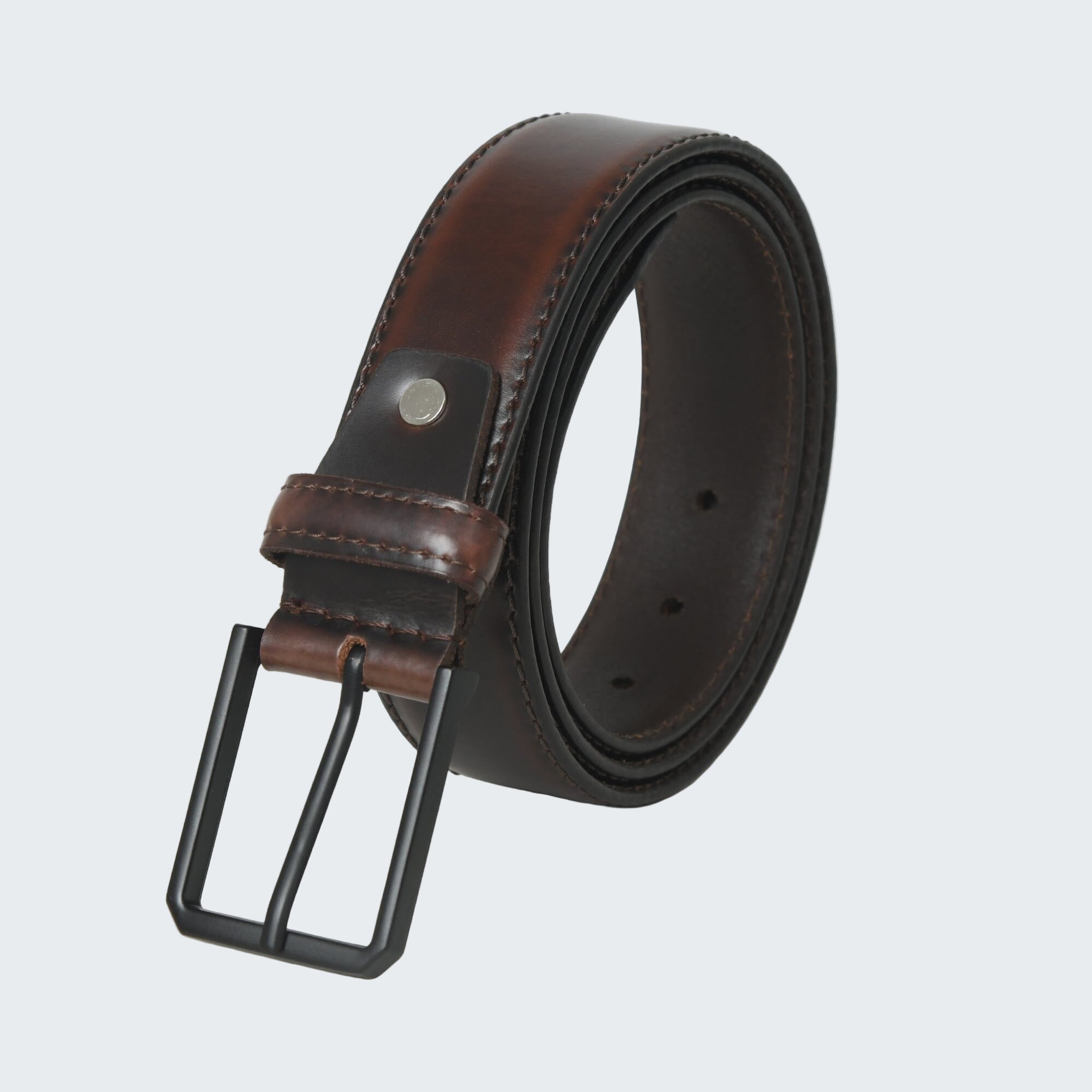 Brown leather belt with a black buckle on a white background