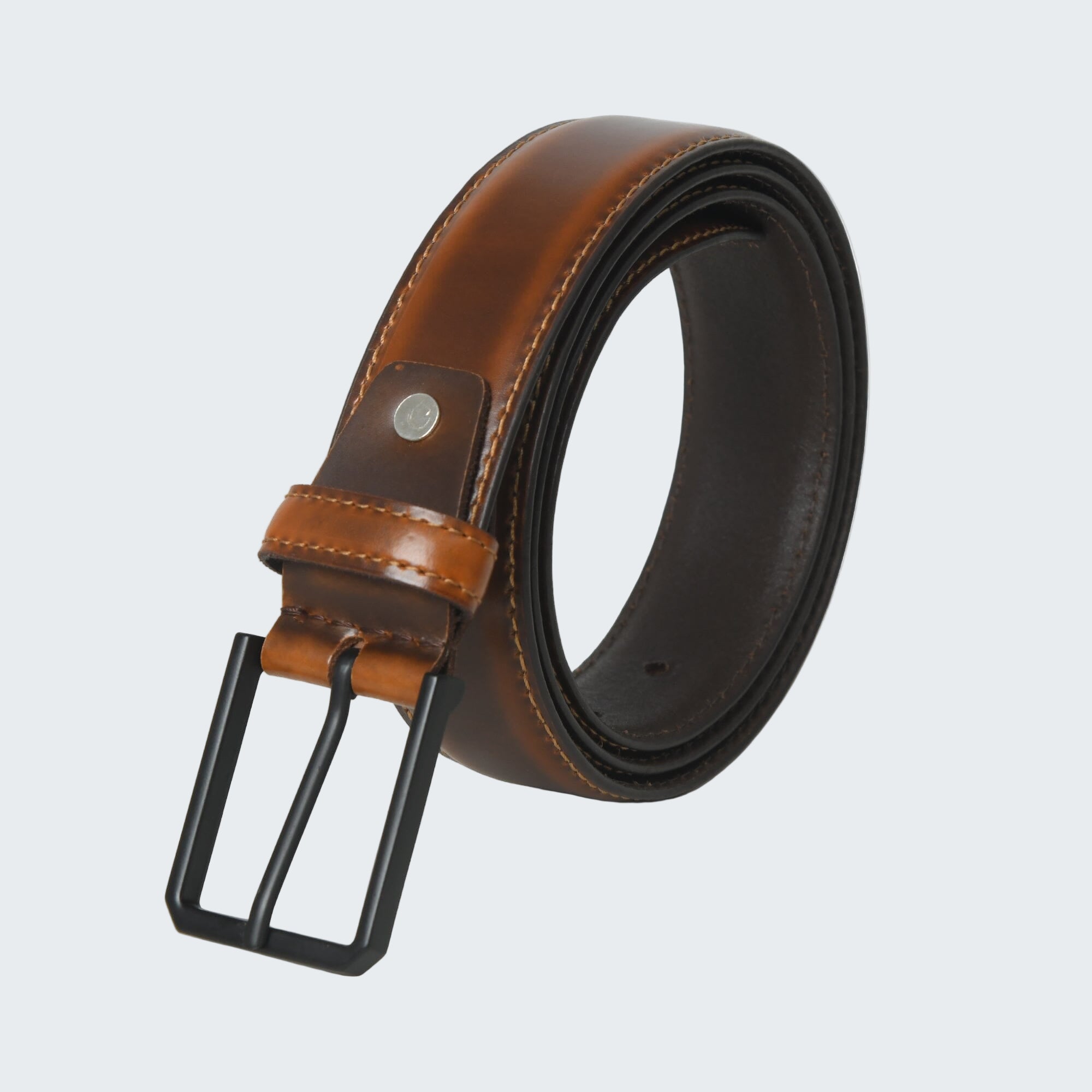 Brown leather belt with black buckle on a white background