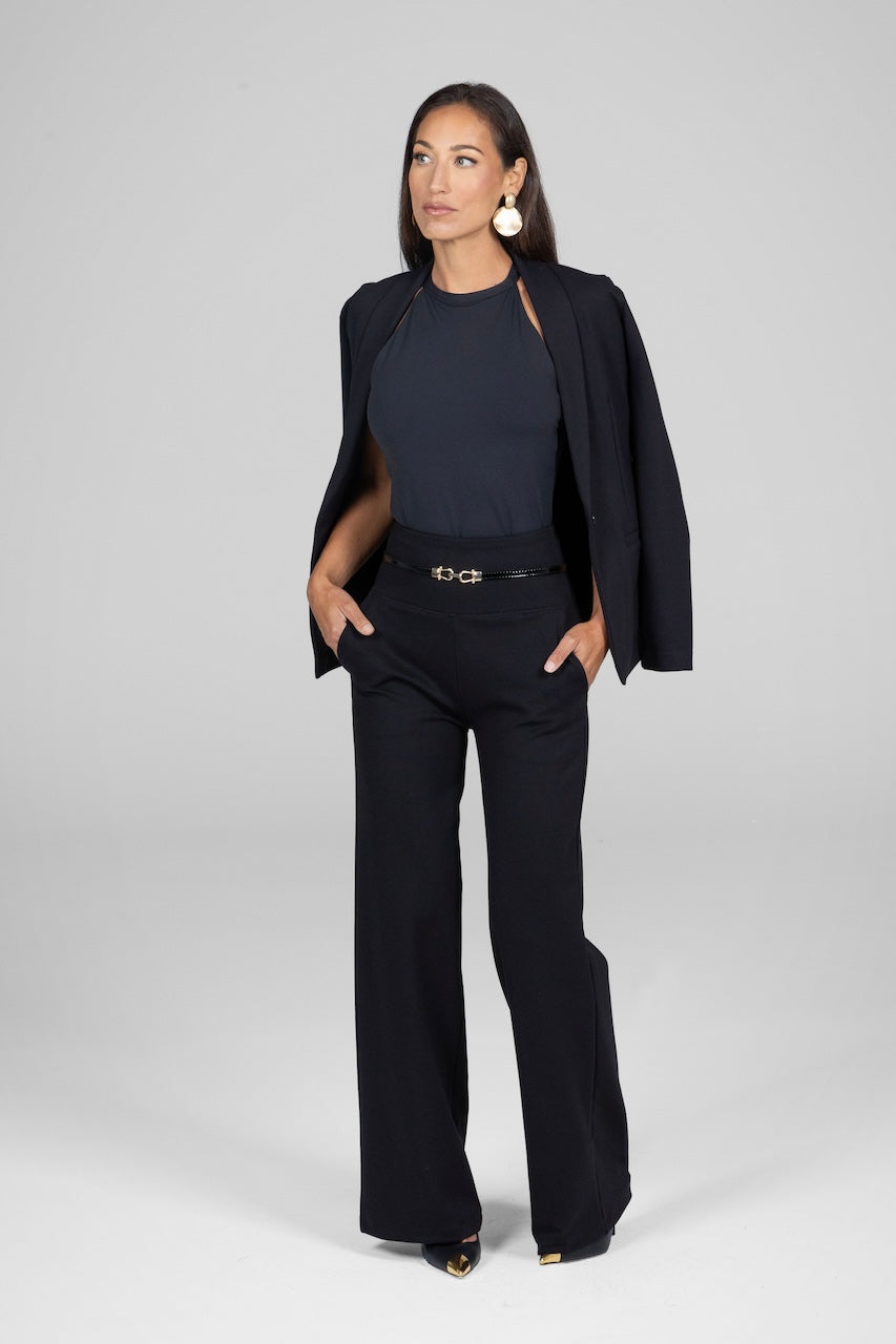 Woman wearing a black suit with a white background