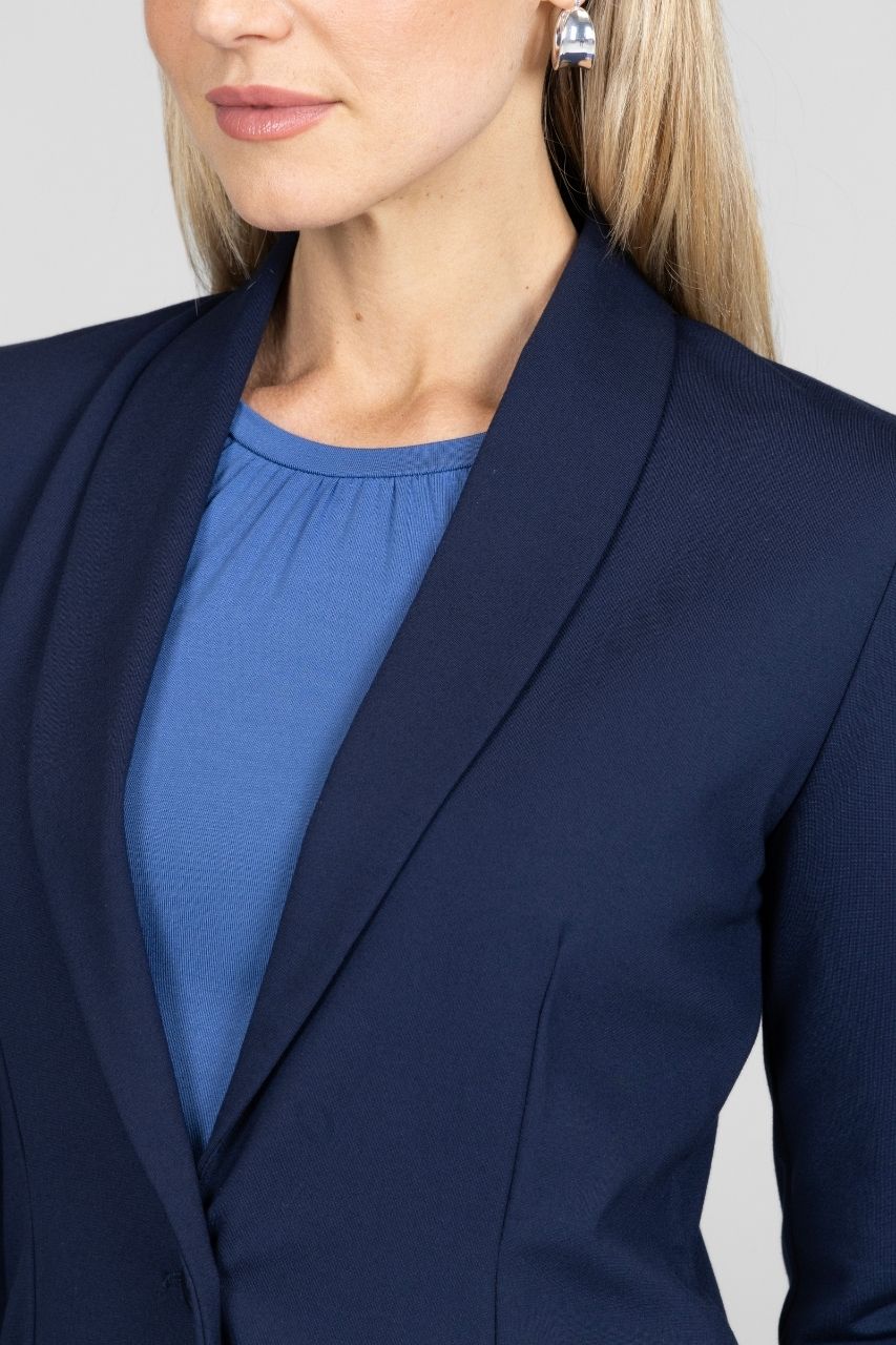 Navy blazer worn by a person with a plain background