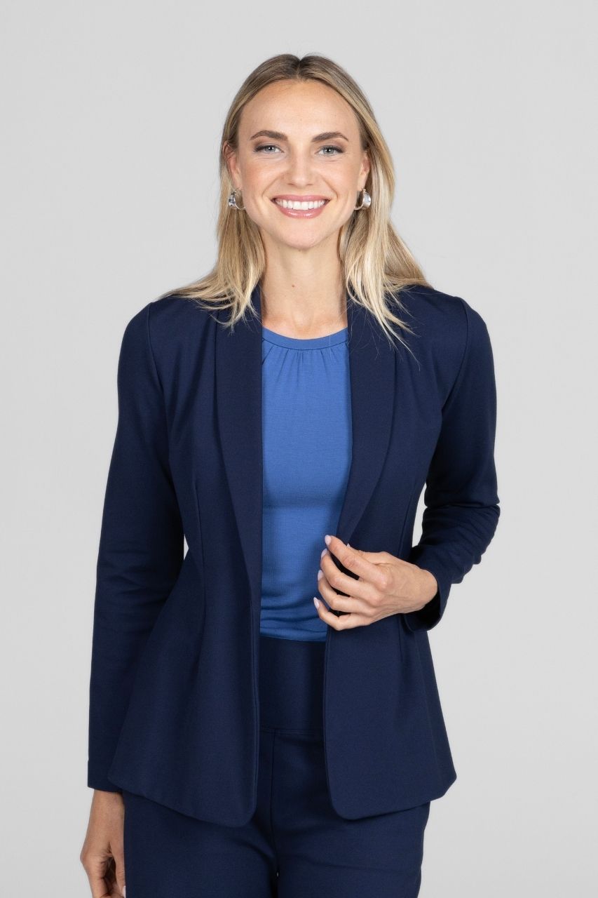 Woman wearing a navy blue suit with a white background
