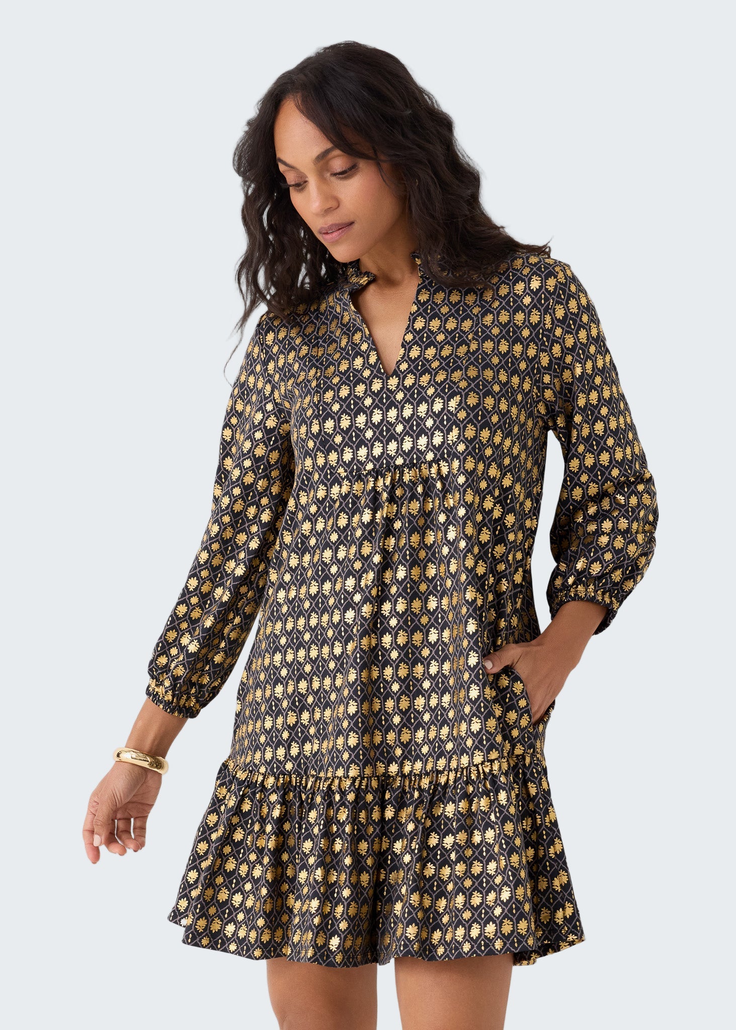 Woman wearing a patterned dress on a white background