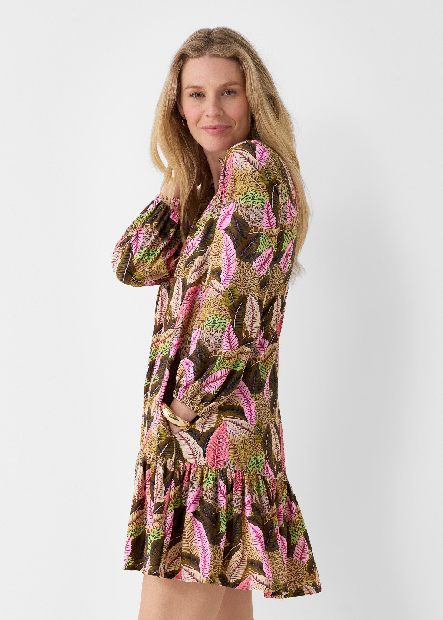 Woman wearing a patterned dress on a white background