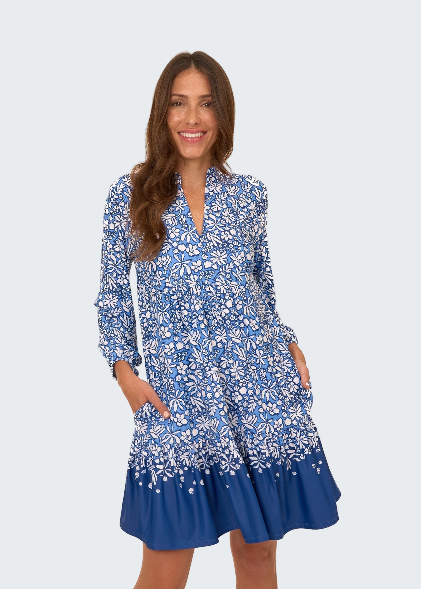 Woman wearing a blue floral dress on a white background