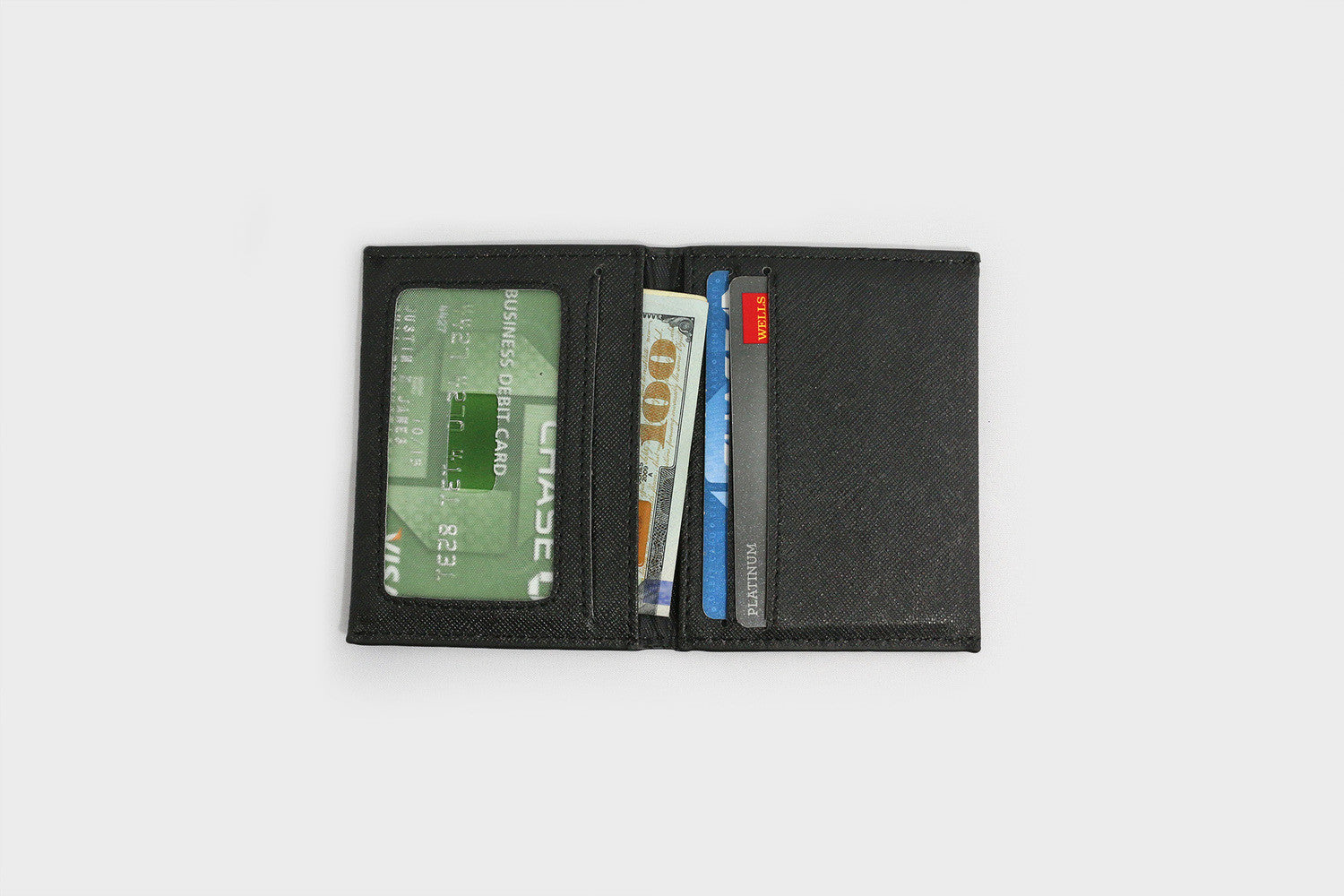 Black wallet with cards and money on a white background