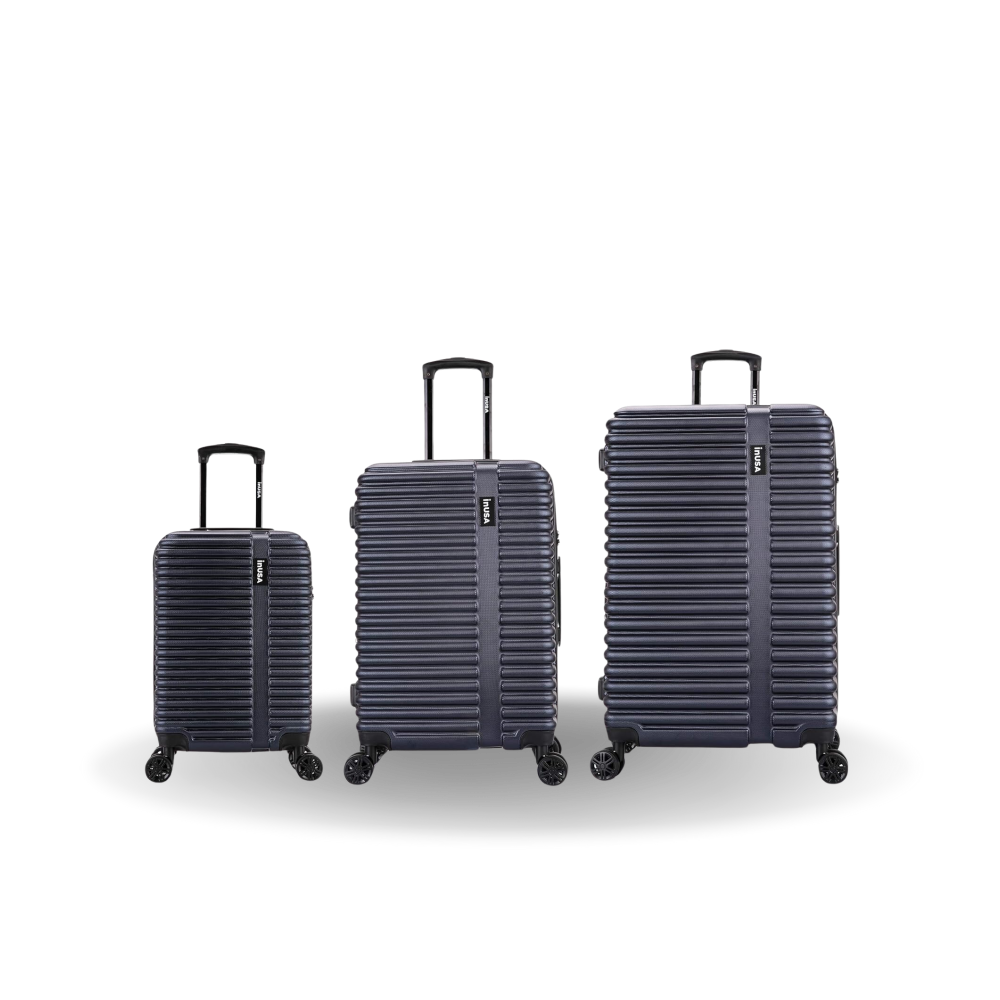 Three navy blue suitcases of different sizes on a white background