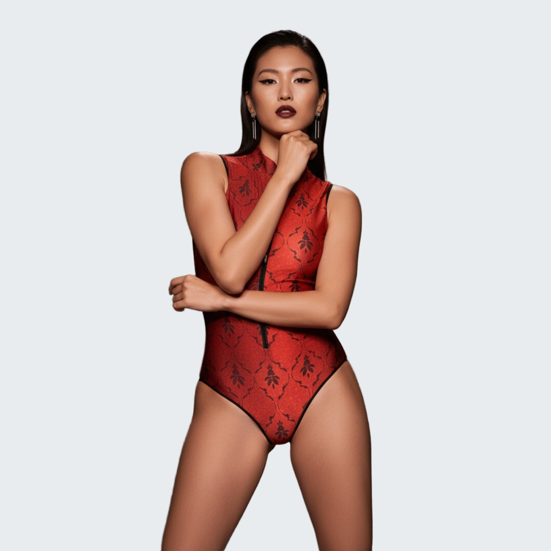 Woman wearing a red lace bodysuit against a dark background