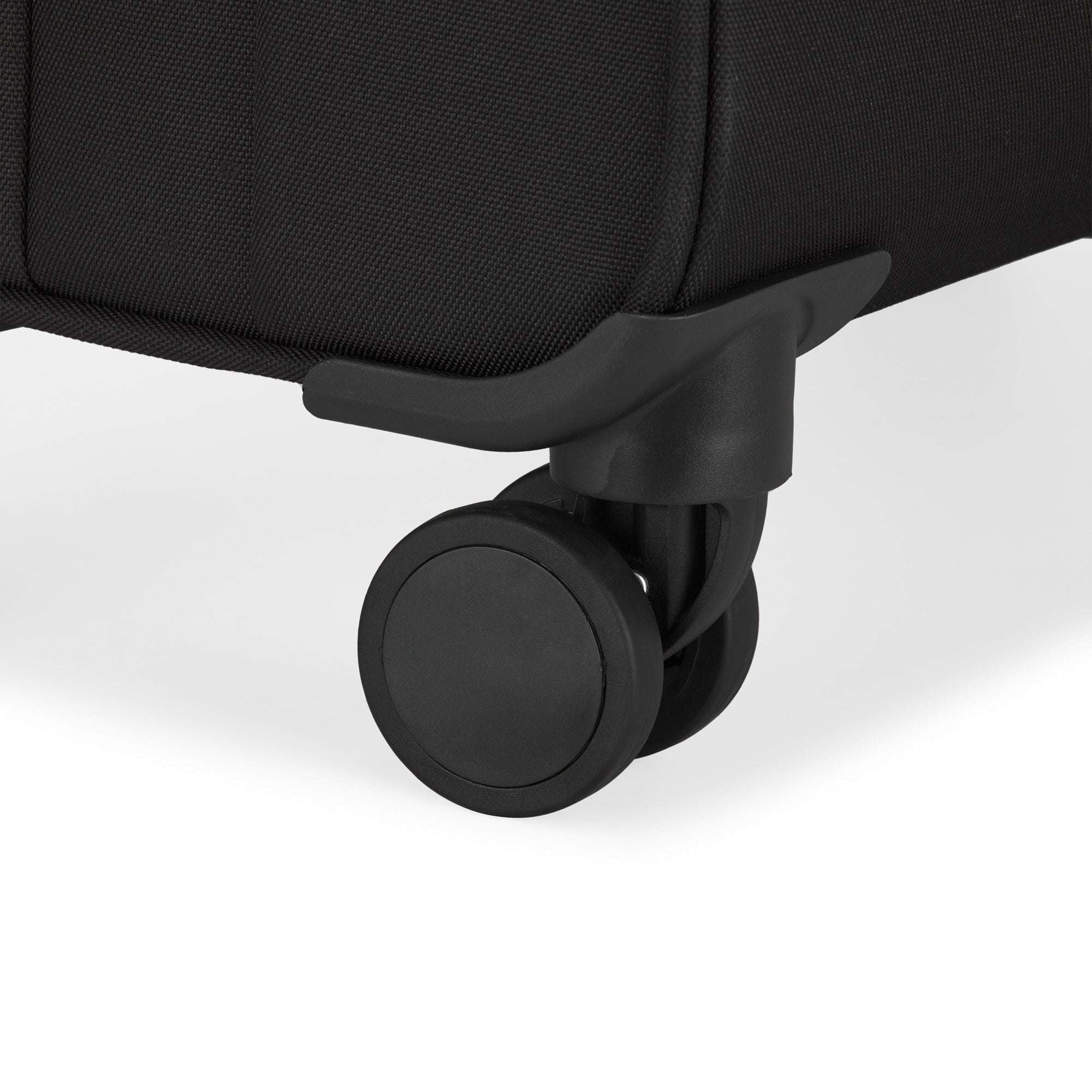 Close-up of a black suitcase wheel on a white background