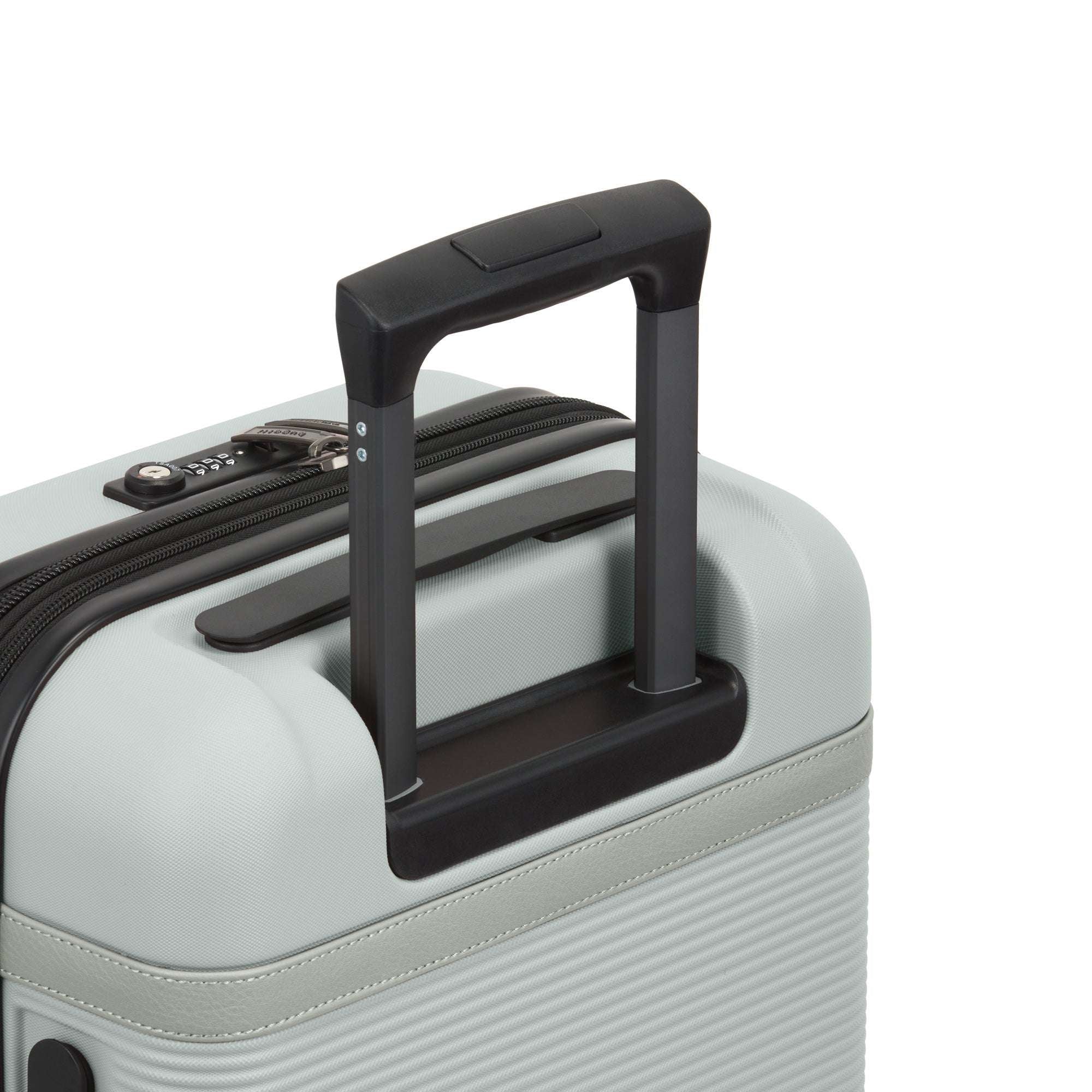 Close-up of a suitcase handle on a light gray suitcase with a white background