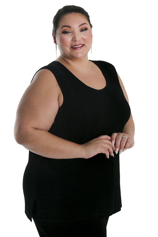 Woman wearing a black sleeveless top on a white background