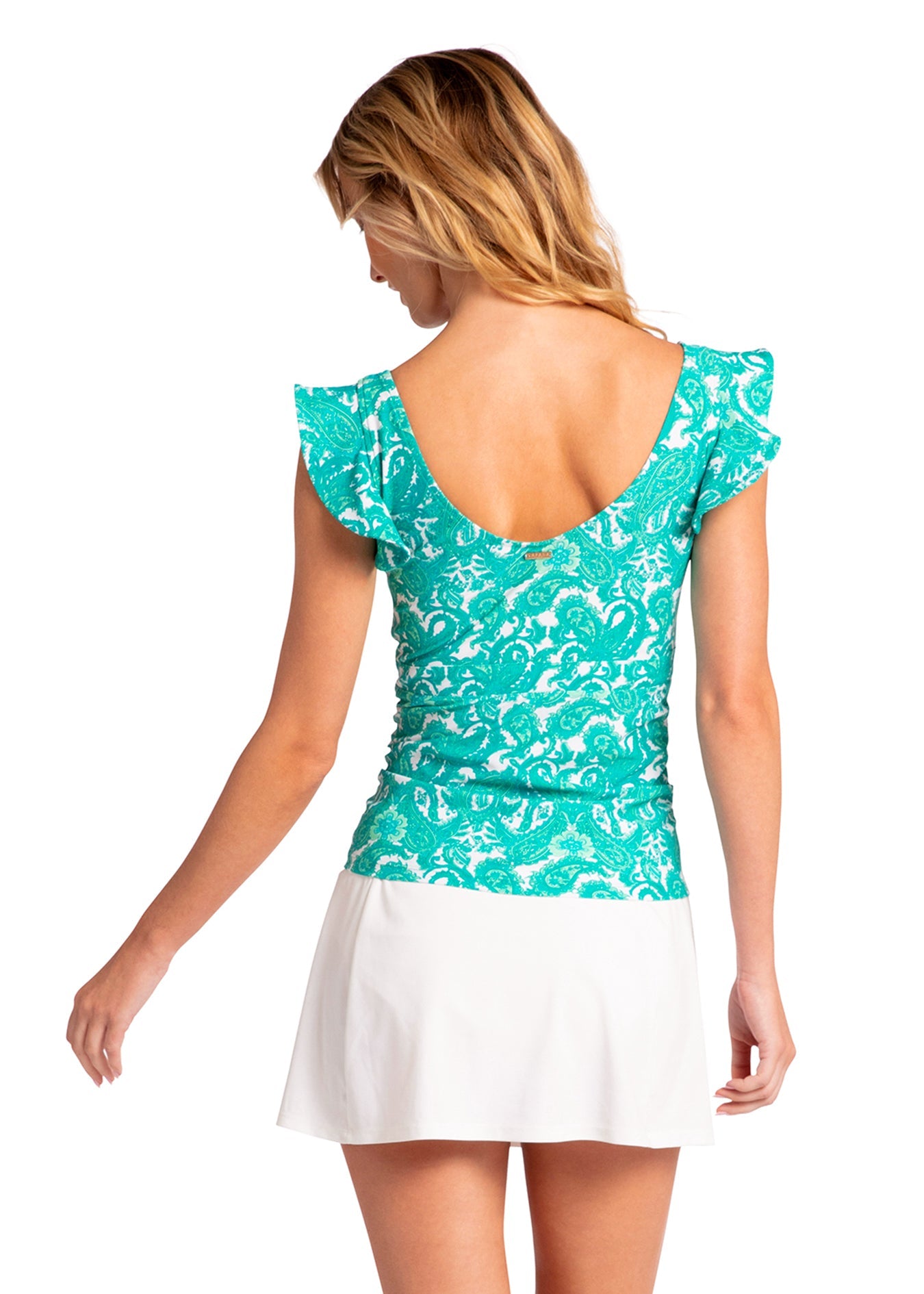 Woman wearing a turquoise patterned top and white skirt on a white background