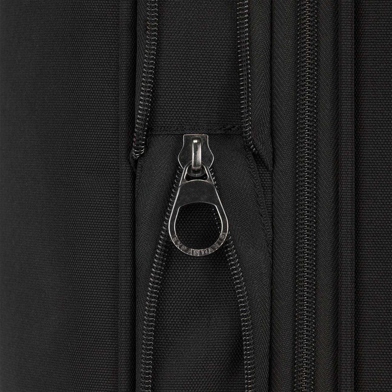 Close-up of a black zipper on a black background