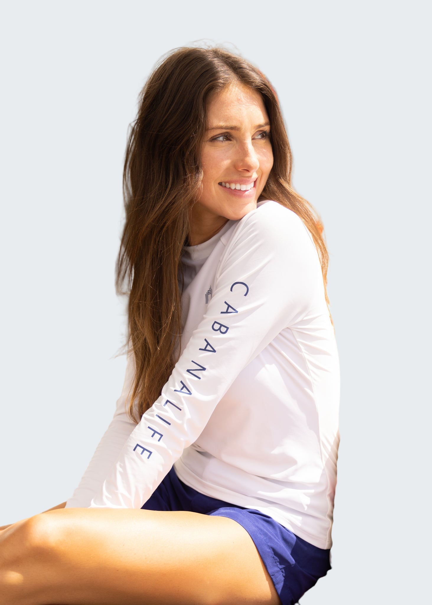 Woman wearing a 'Cabana Life' shirt sitting on a boat.