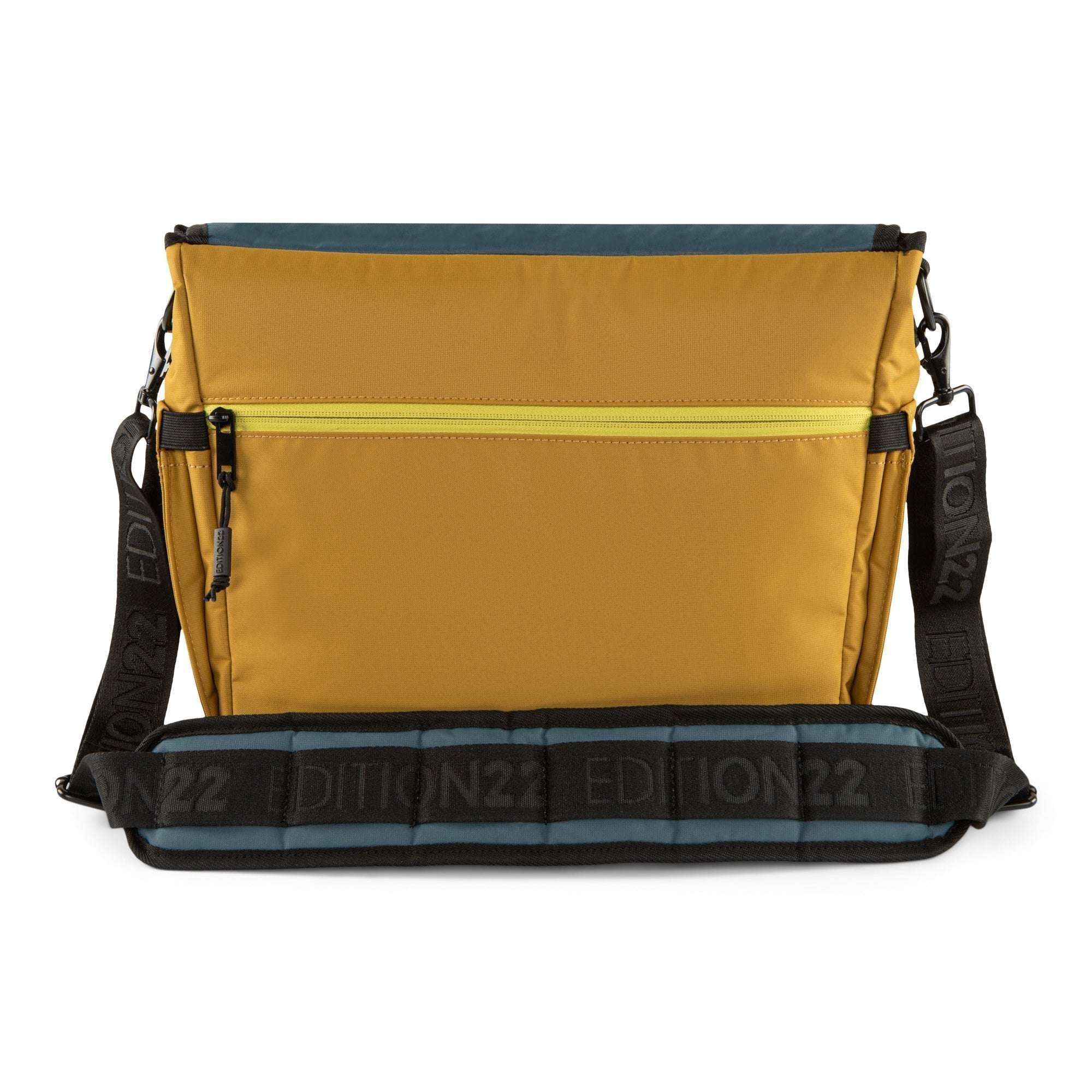 Yellow bag with black strap and visible branding on a white background