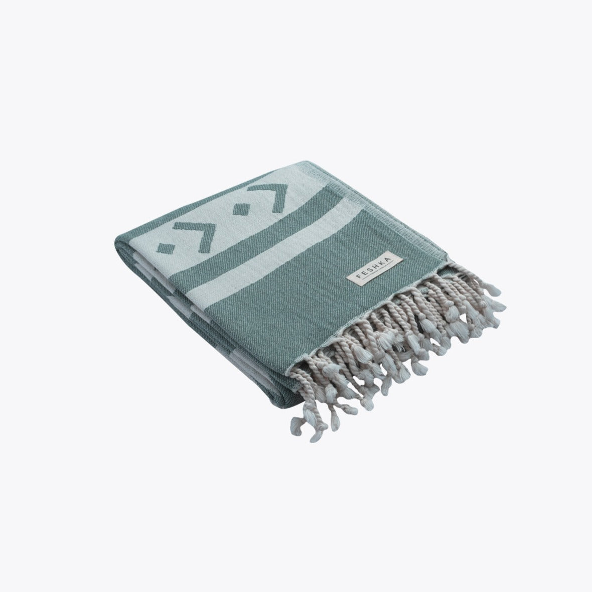 Green and white towel with tassels on a white background