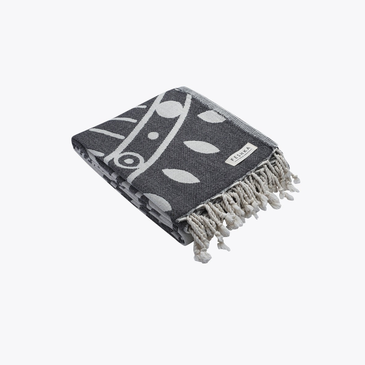 Gray towel with white leaf pattern and fringes on a white background