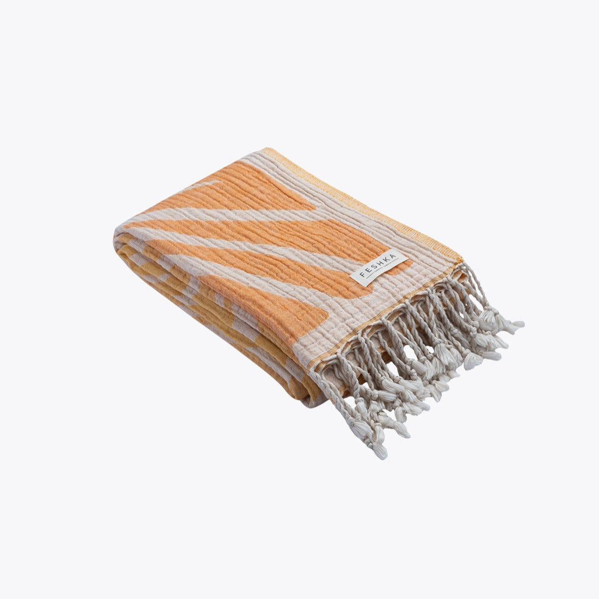 Orange and white striped towel with tassels on a white background