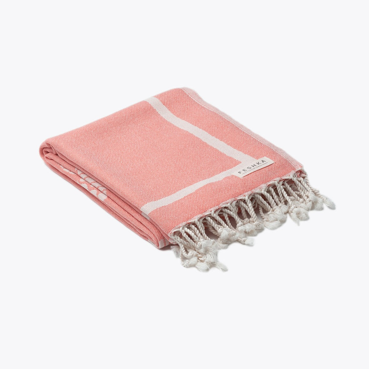 Pink towel with white stripes and fringes on a white background
