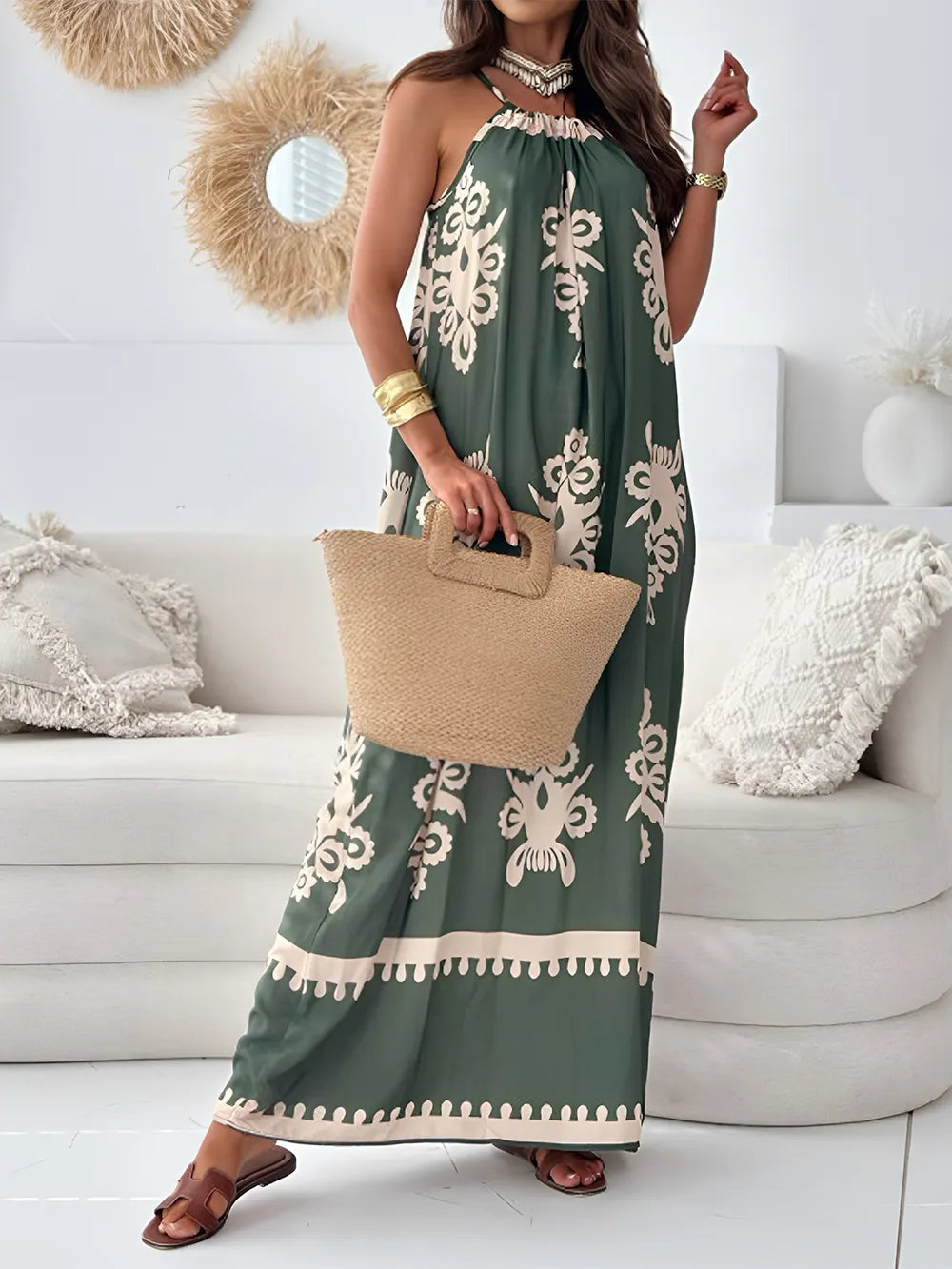 A woman wearing a white and black printed spaghetti strap sleeveless maxi dress with a sheer neckline.