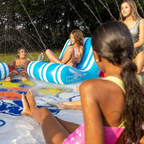 Children playing on inflatable slides at a water park
