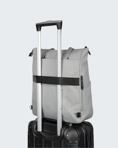 Gray rolling duffel bag with a black handle on a white background