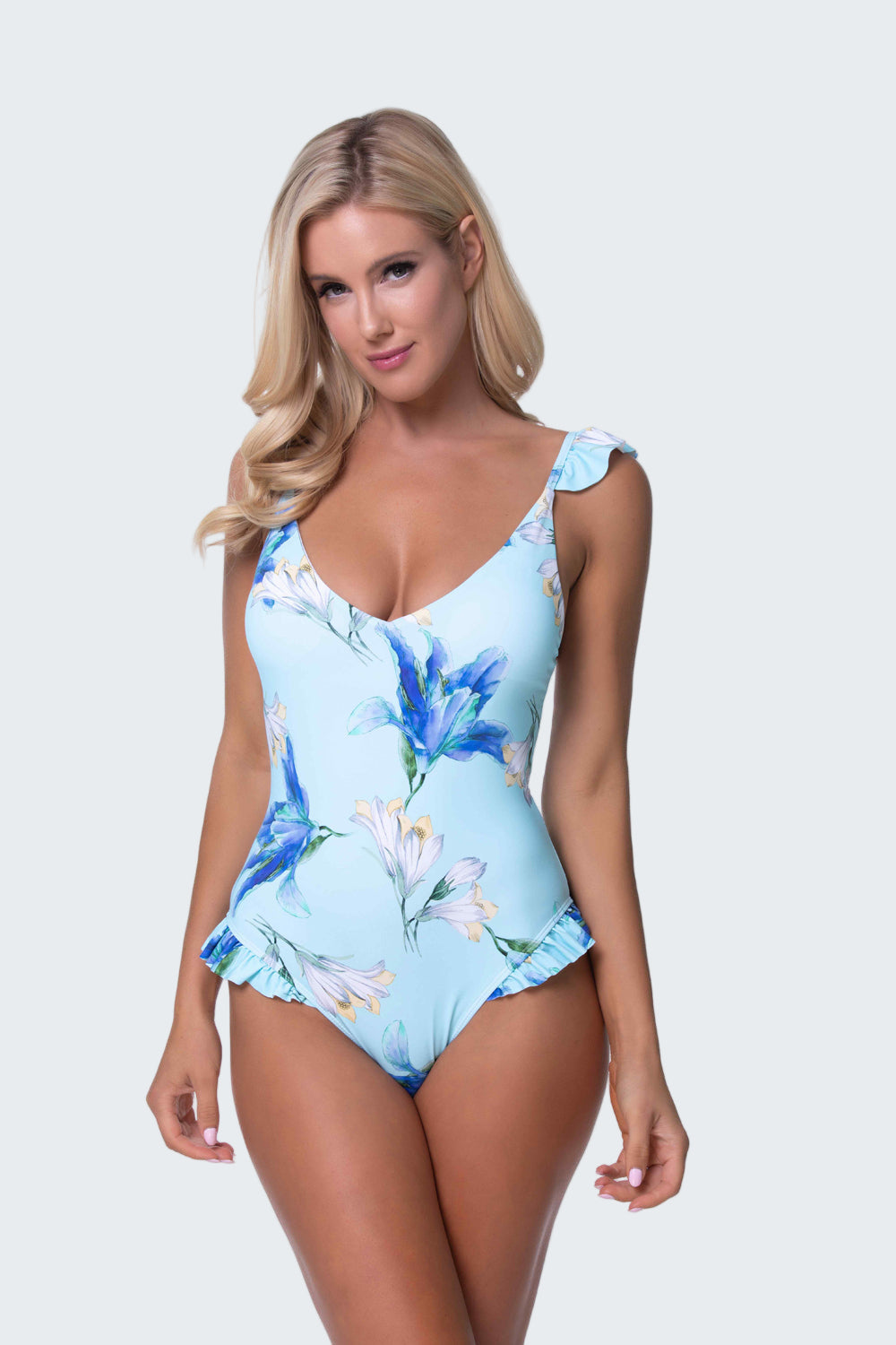 Woman wearing a blue floral one-piece swimsuit on a white background