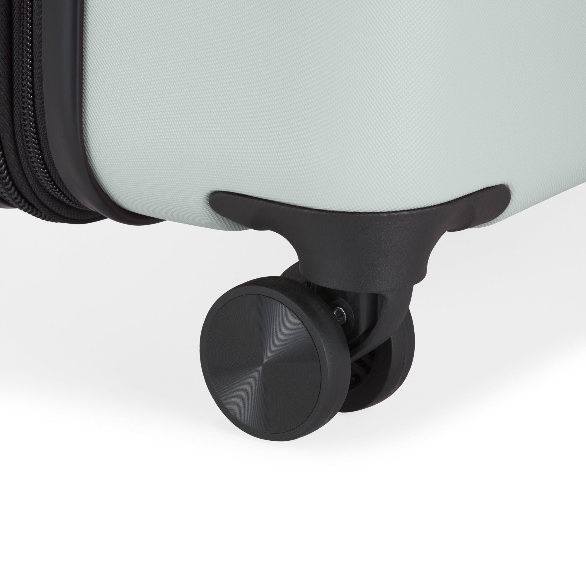 Close-up of a suitcase wheel on a light gray background