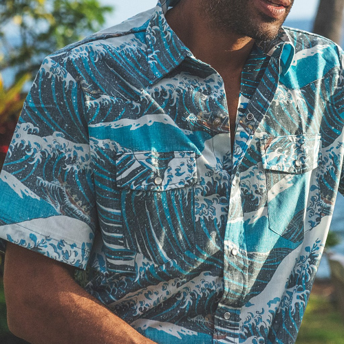 Person wearing a blue and white patterned shirt outdoors
