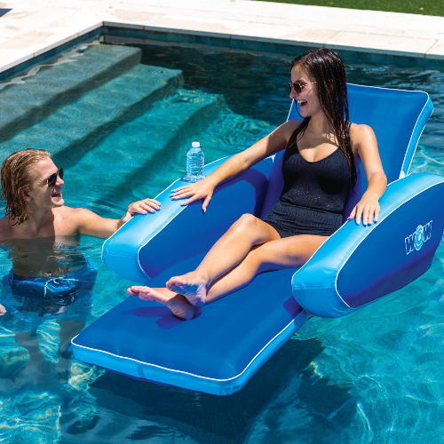 Two people relaxing on inflatable pool lounge chairs in a pool.