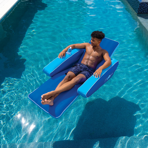 Man relaxing on a blue inflatable lounge in a pool