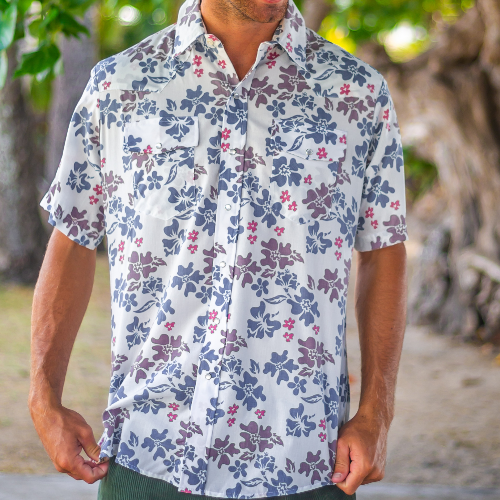 Person wearing a floral short-sleeve shirt outdoors