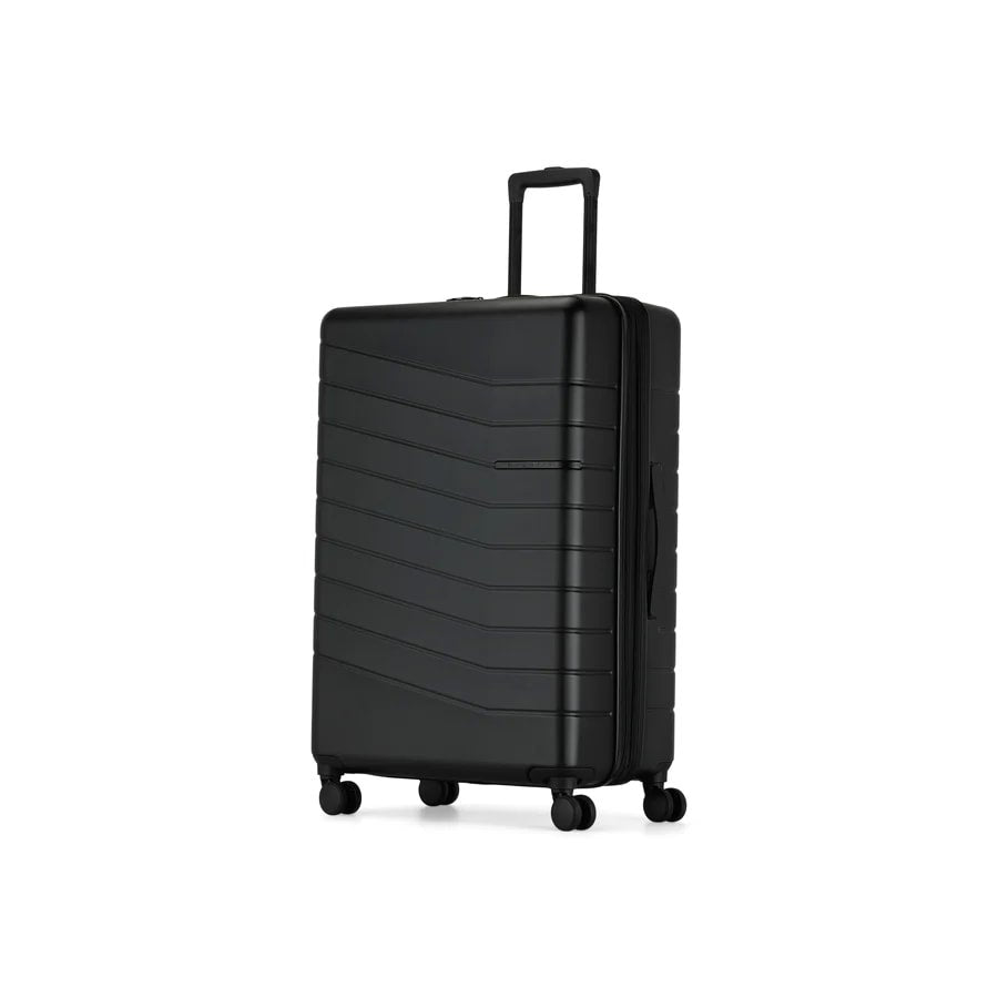 Black suitcase with a textured surface on a white background
