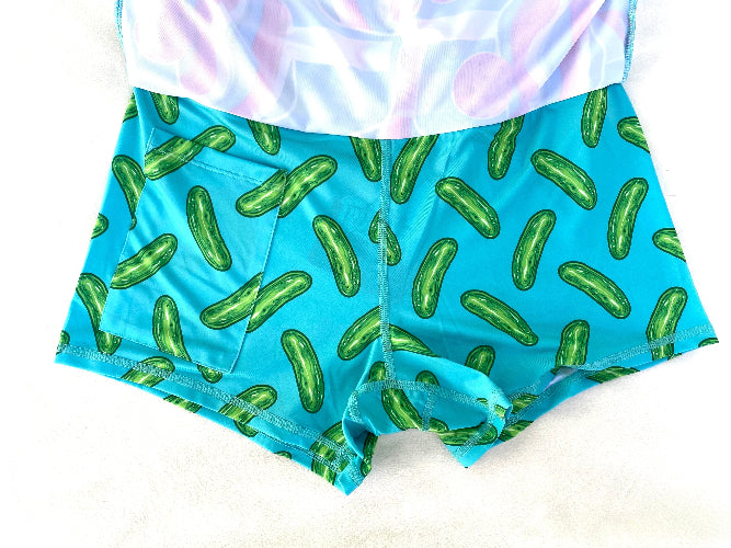 Blue shorts with pickle pattern and white top on a light background