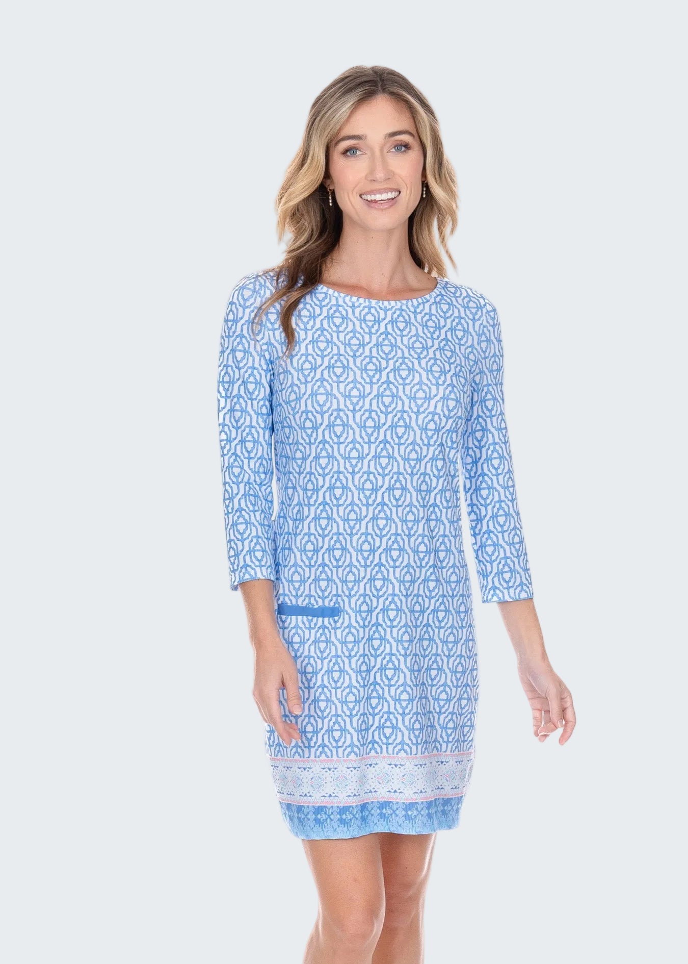 Woman wearing a blue patterned dress on a white background