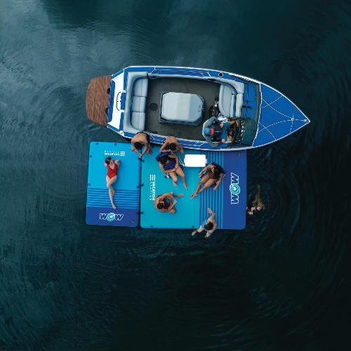 Top-down view of a boat with people on a floating platform in the water
