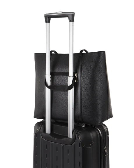 Black suitcase with a matching black backpack on a white background