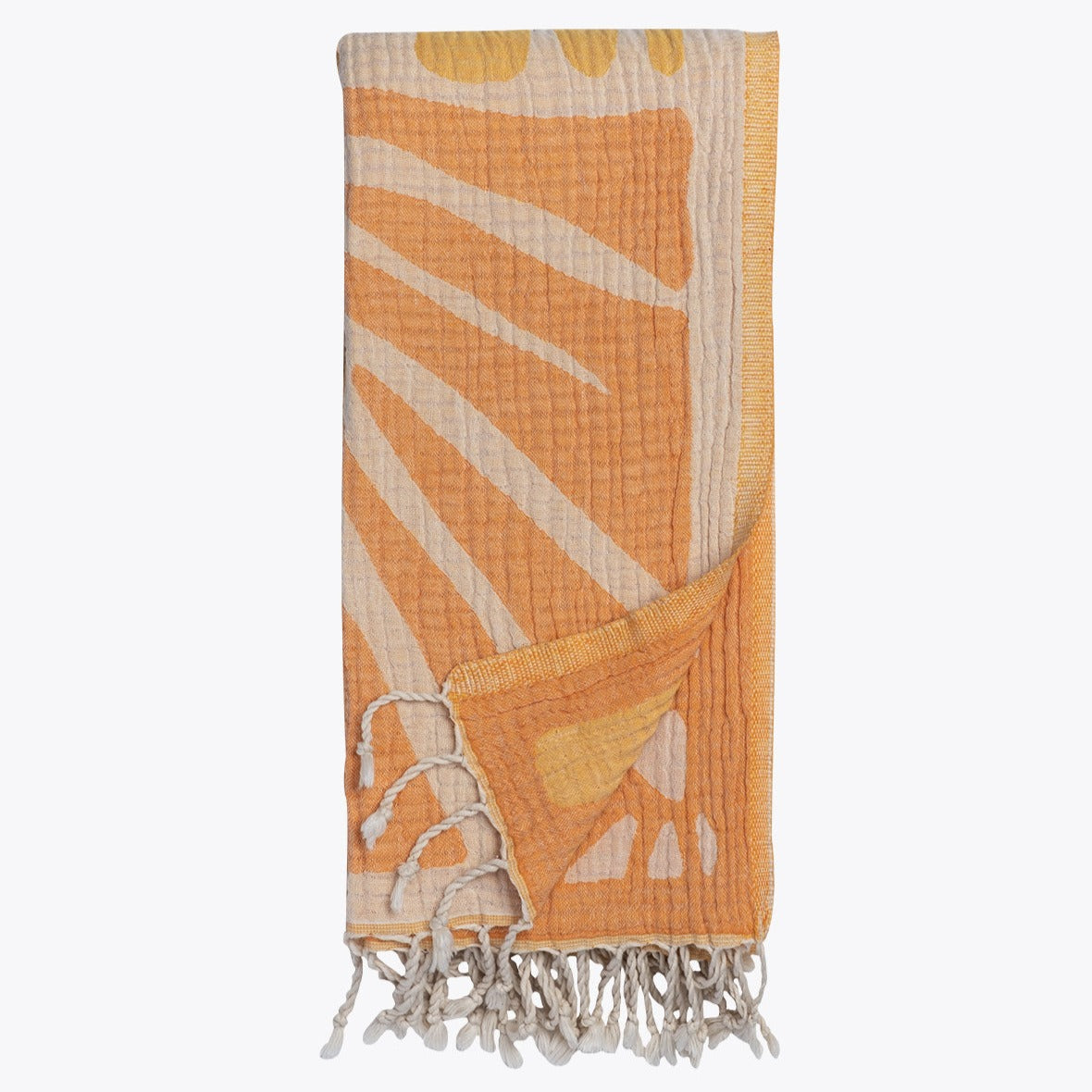 Orange and beige towel with leaf pattern on a white background