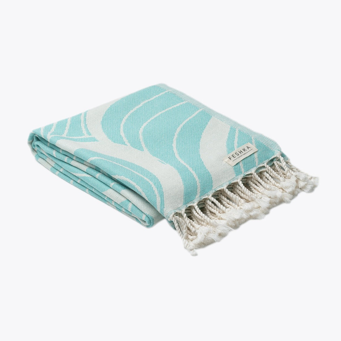 Turquoise and white patterned towel with fringes on a white background